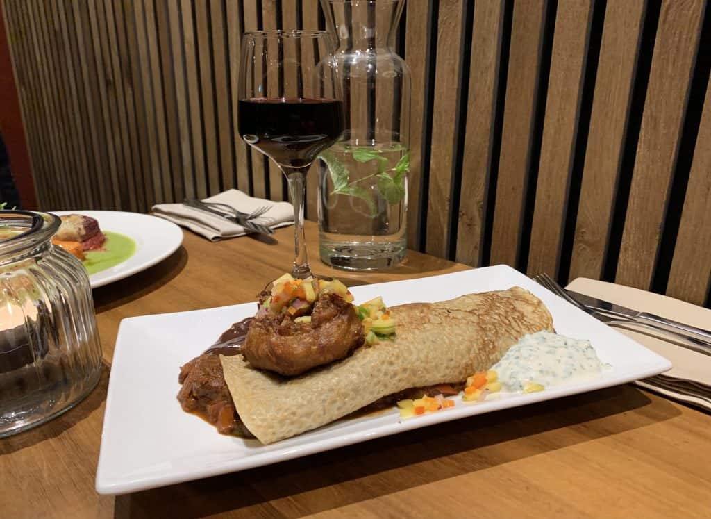 David Bann restaurant. A savoury pancake with a glass of red wine in the background, Located in Edinburgh