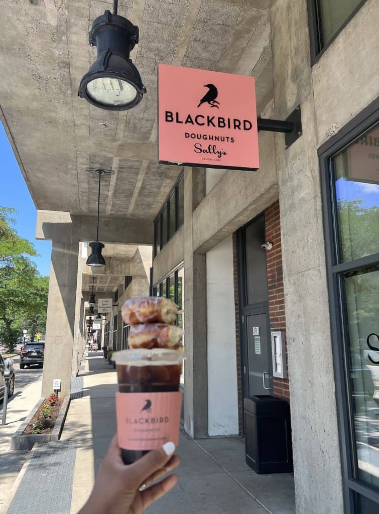 Cafes and Brunch Spots in Boston: Blackbird Doughnuts sign with coffee and doughnuts