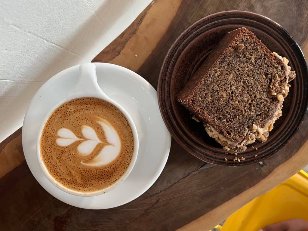 Cappuccino and cake on wooden counter at Gracenote coffee