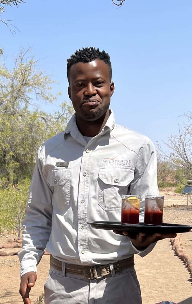 Desert Rhino Camp waiter with welcome drinks