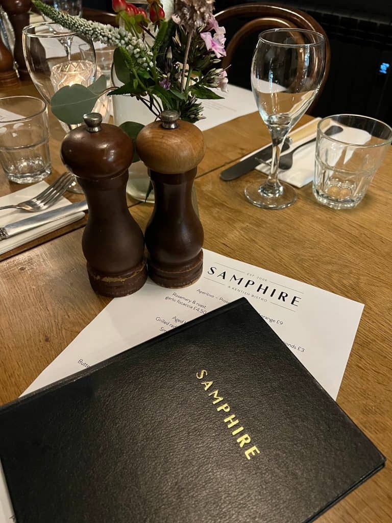 Samphire restaurant menu, salt and pepper sakers and wine glasses on the table in Whitstable