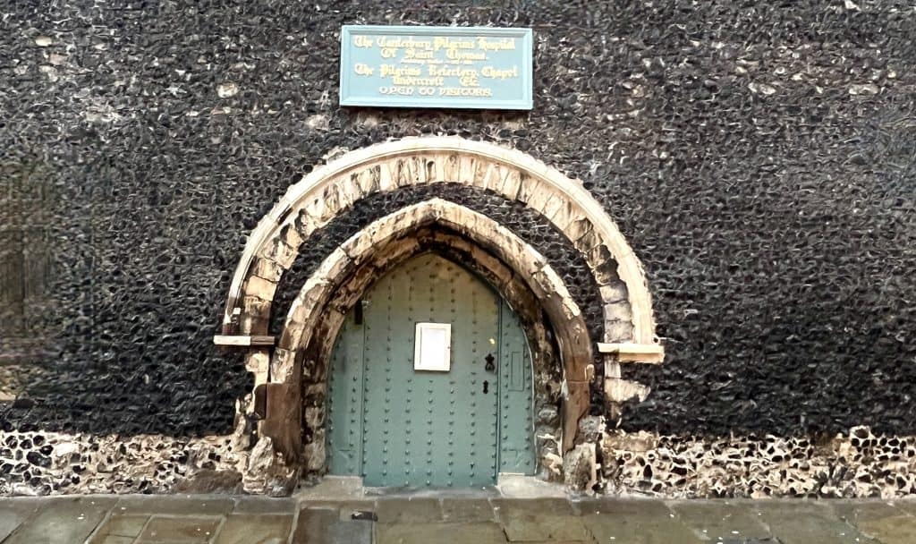 The best of Canterbury, Eastbridge Hospital duck egg green door with signage