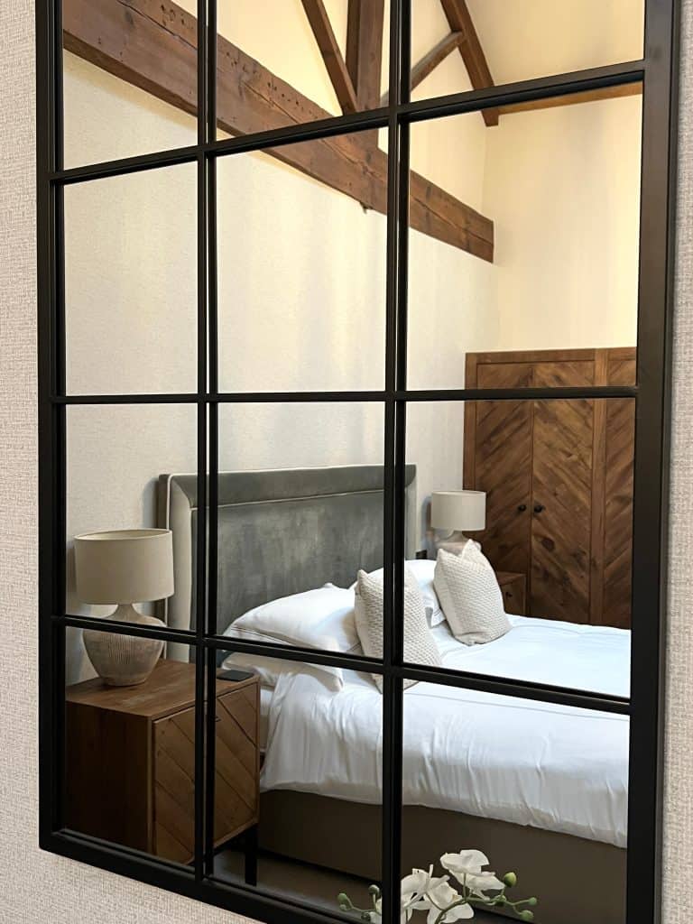 Reflection of bed in mirror