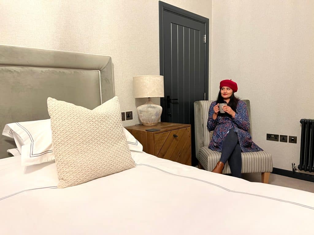 Bejal in The Merchant's Yard bedroom with hot drink