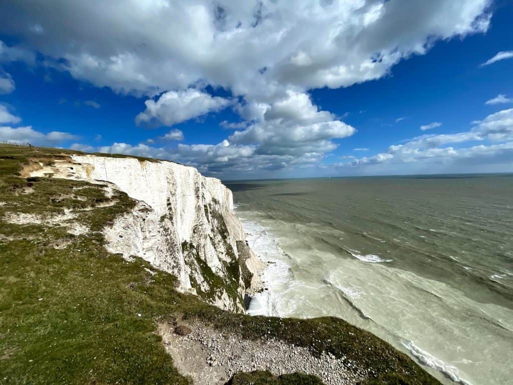 White cliffs of Dover with blue skies and fluffy white clouds