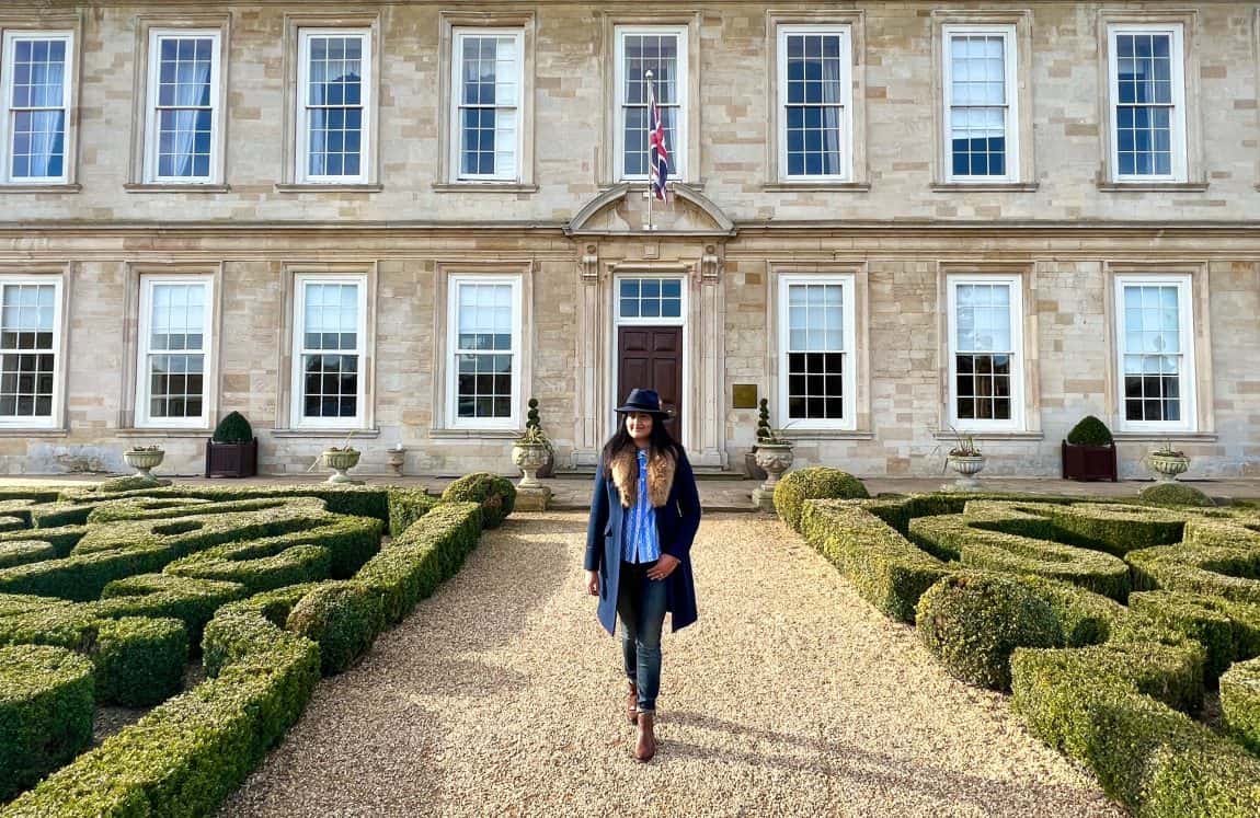 bejal walking down middle pathway of Stapleford Park main house