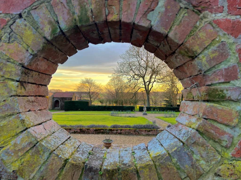 The rose garden and sunset from a window in the walled garden