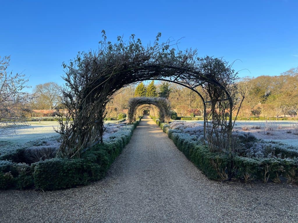 Archways in walled garden with frost