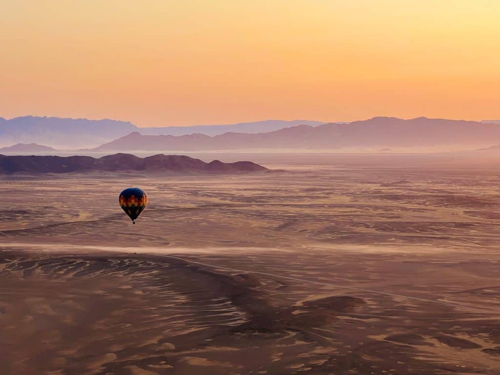 Hot air balloon over Sossusvlei landscape at sunset