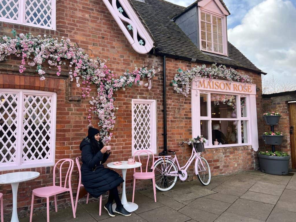 Maison Rose exterior with Bejal sitting outside with cappuccino