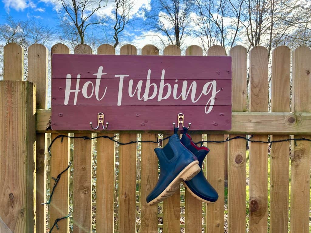 Mallory Meadows Boutique Cabin Stay: hot tub sign with Bejal's Joules wellies hanging up