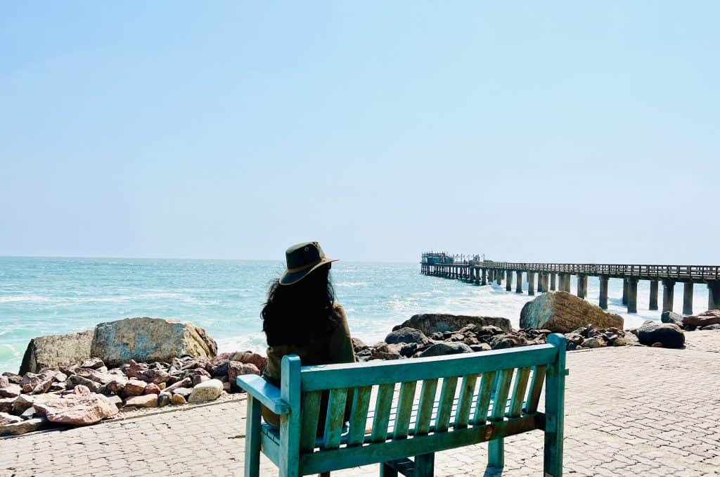 Things to do in Swakopmund: Bejal sitting on bench overlooking the pier