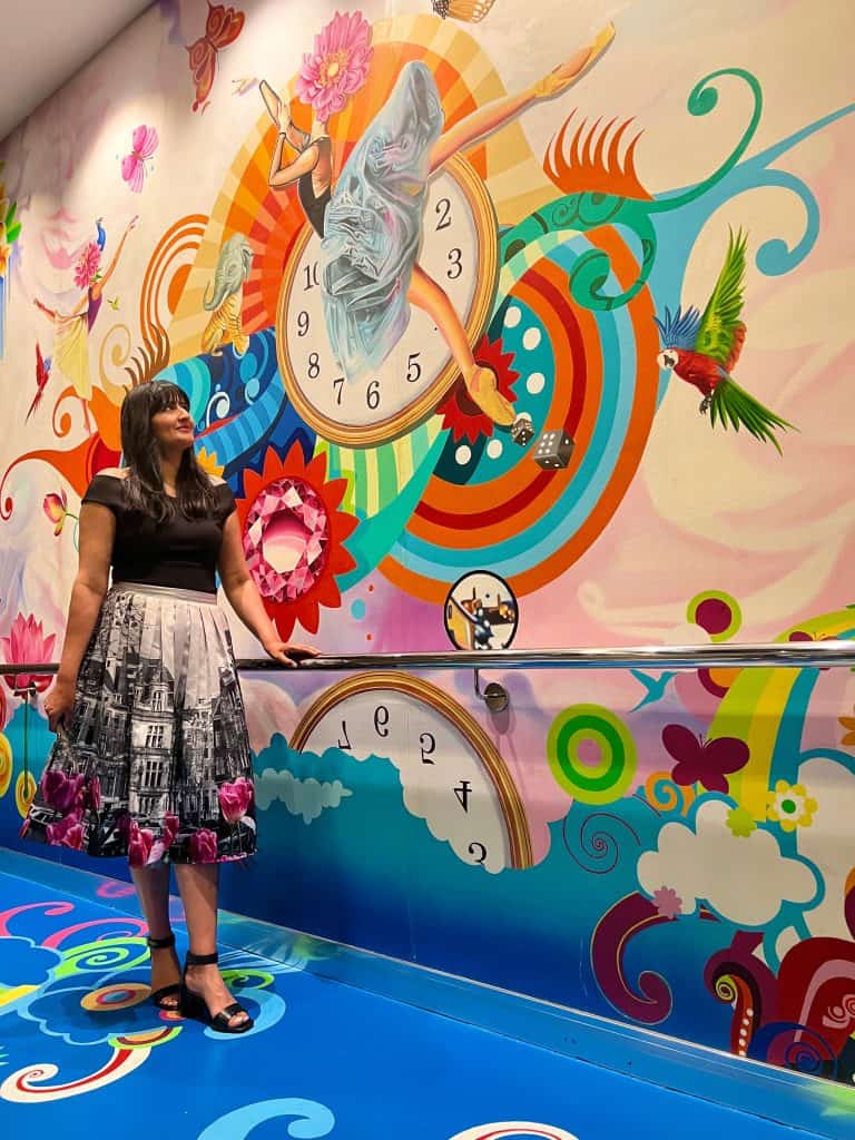 Bejal behind stair murals on ship