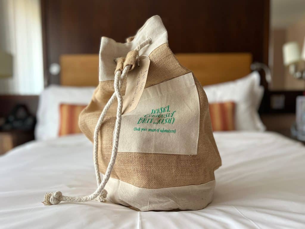Sustainable Jersey: Visit Jersey hessian bag on bed at Club HOtel & Spa.