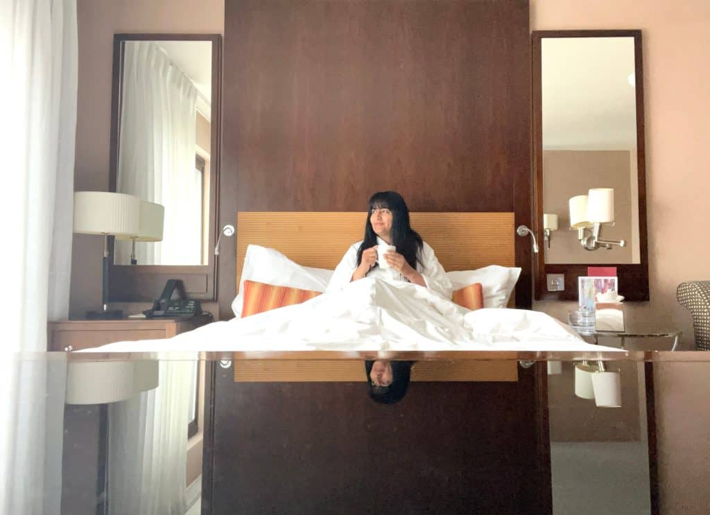 Sustainable Jersey: Bejal in bed with fluffy white bath robe