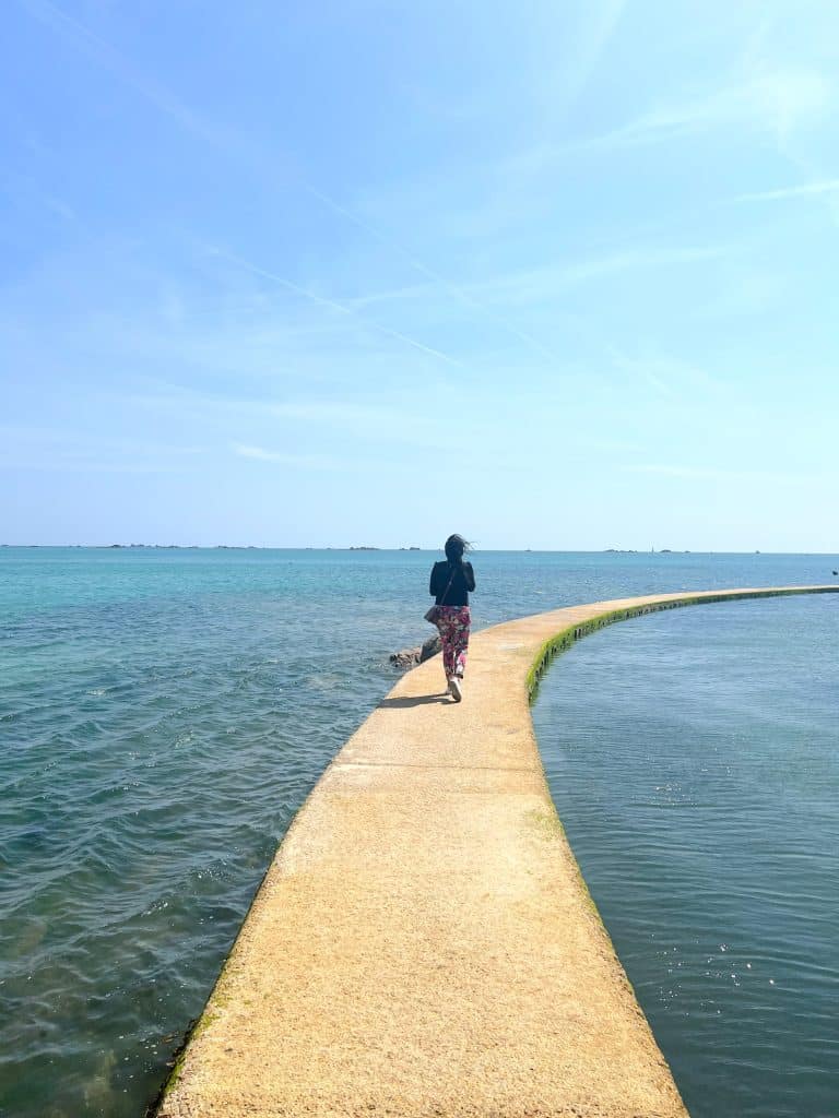 Sustainable Jersey: bejal walking along Lido defence