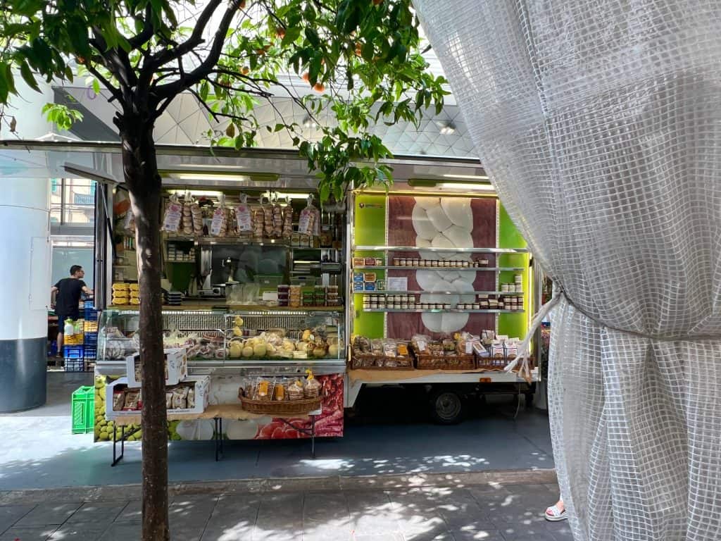 Market in the centre of La Spezia selling flowers and deli items