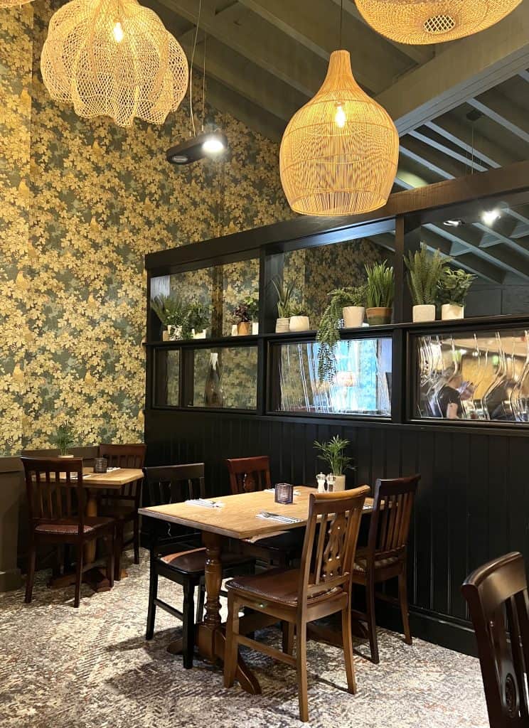 Tables against plant lined black window frame