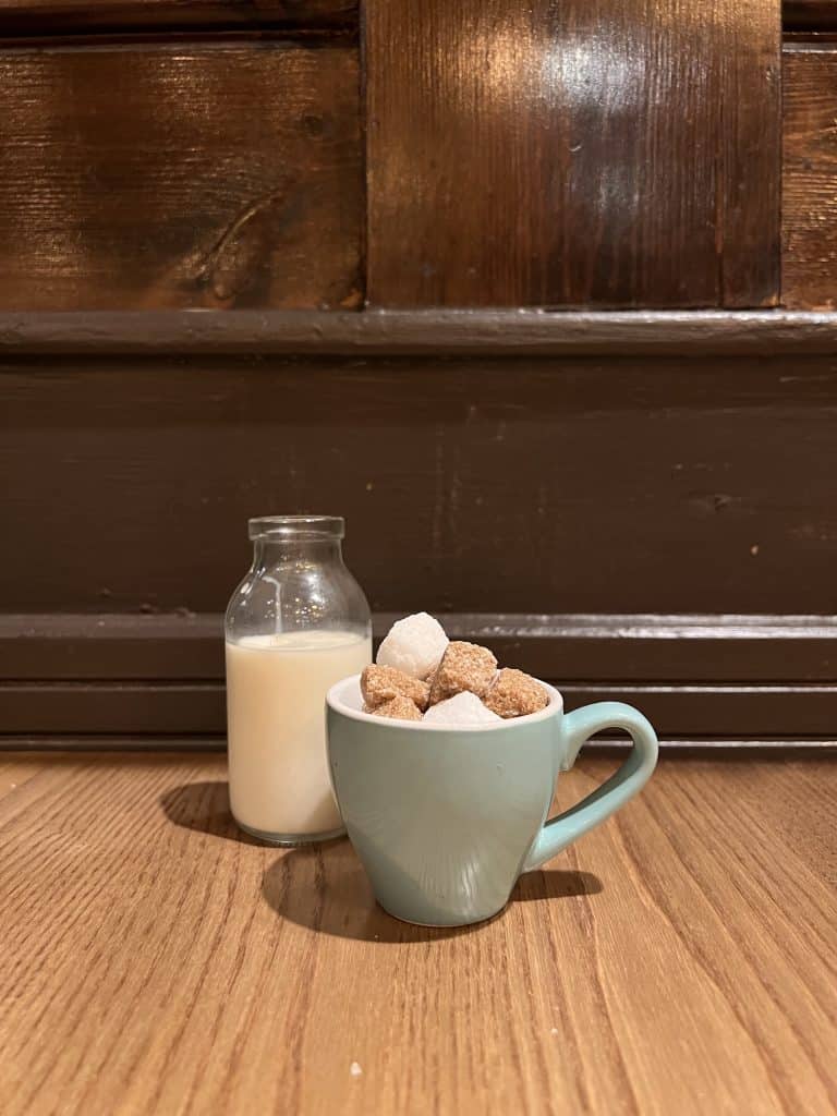 small milk bottle and sugar cube cup