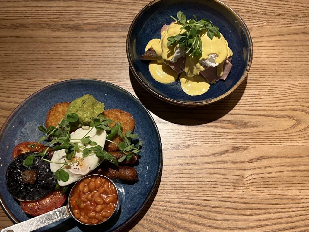 Brunch at The Forge Inn: Eggs Benedict and Vegetarian Full English Breakfast top lay