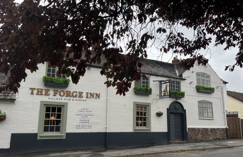 The Forge Inn front exterior of building with autumn trees frame