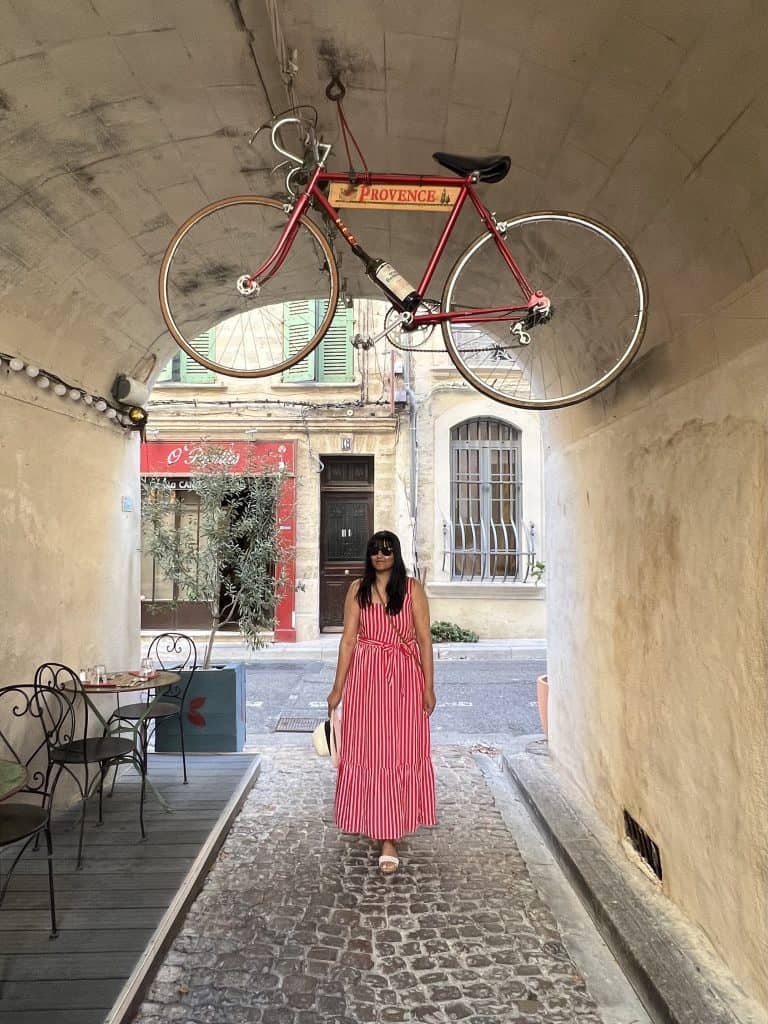 Bejal walking through archway with bike