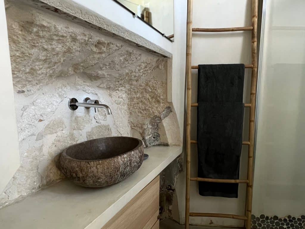 Historic Places to Stay in Avignon: Le Lieu bathroom sink with part of convent wall