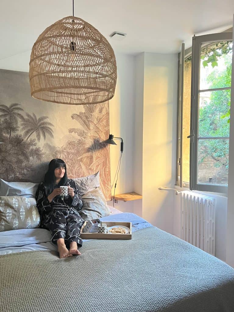 Historic Places to Stay in Avignon: Bejal sat on bed with drink at Le Lieu