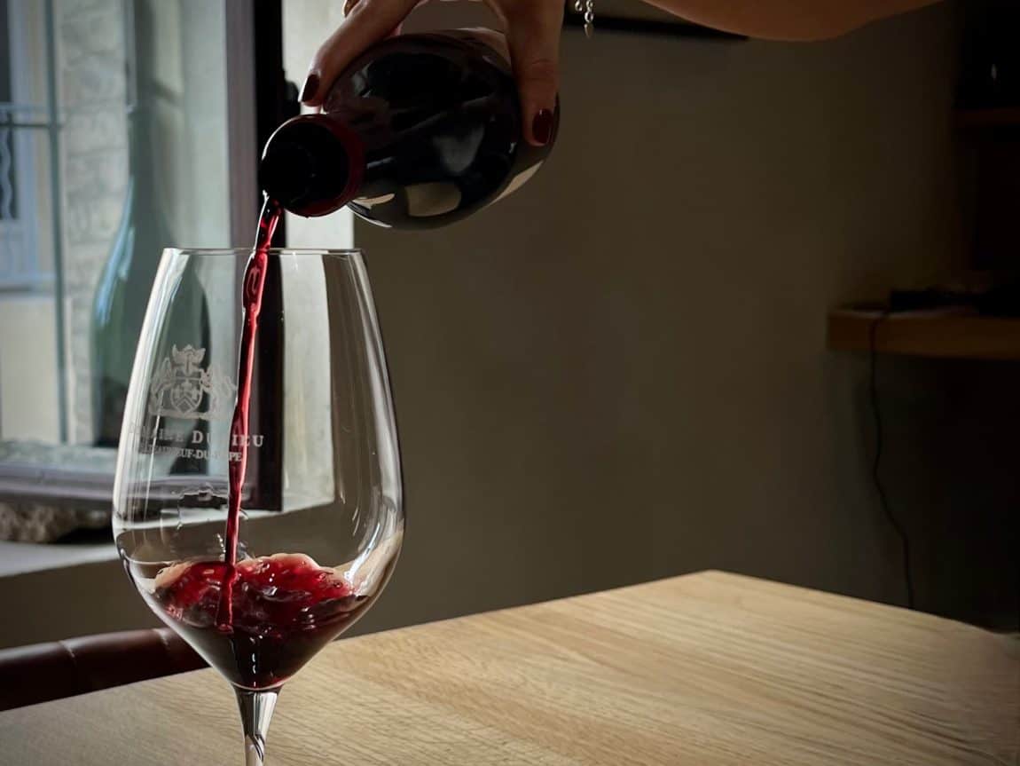 Wineries in Châteauneuf-du-Pape: Red wine being poured at Domaine de Durieu