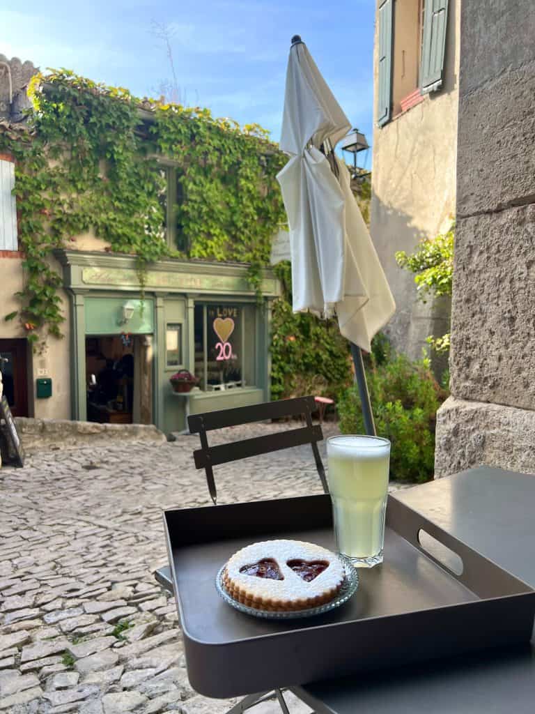 Salon de Thé Eglantine lemonade and shortbread biscuit with cafe in background