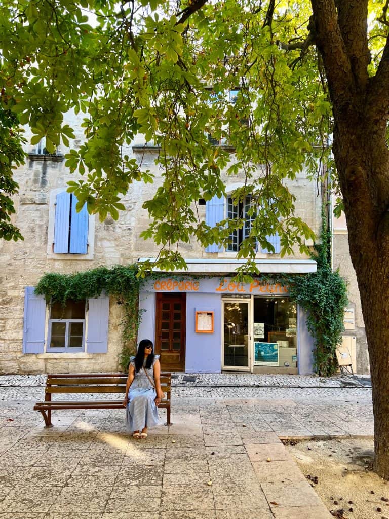 Cities and towns to visit in Provence: Bejal sitting on bench in square in Saint Remy de Provence