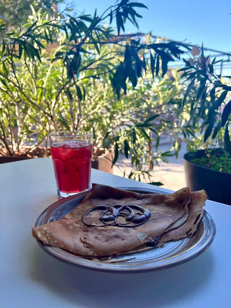 Cafe Tinel Nutella Crepe and strawberry syrup and water