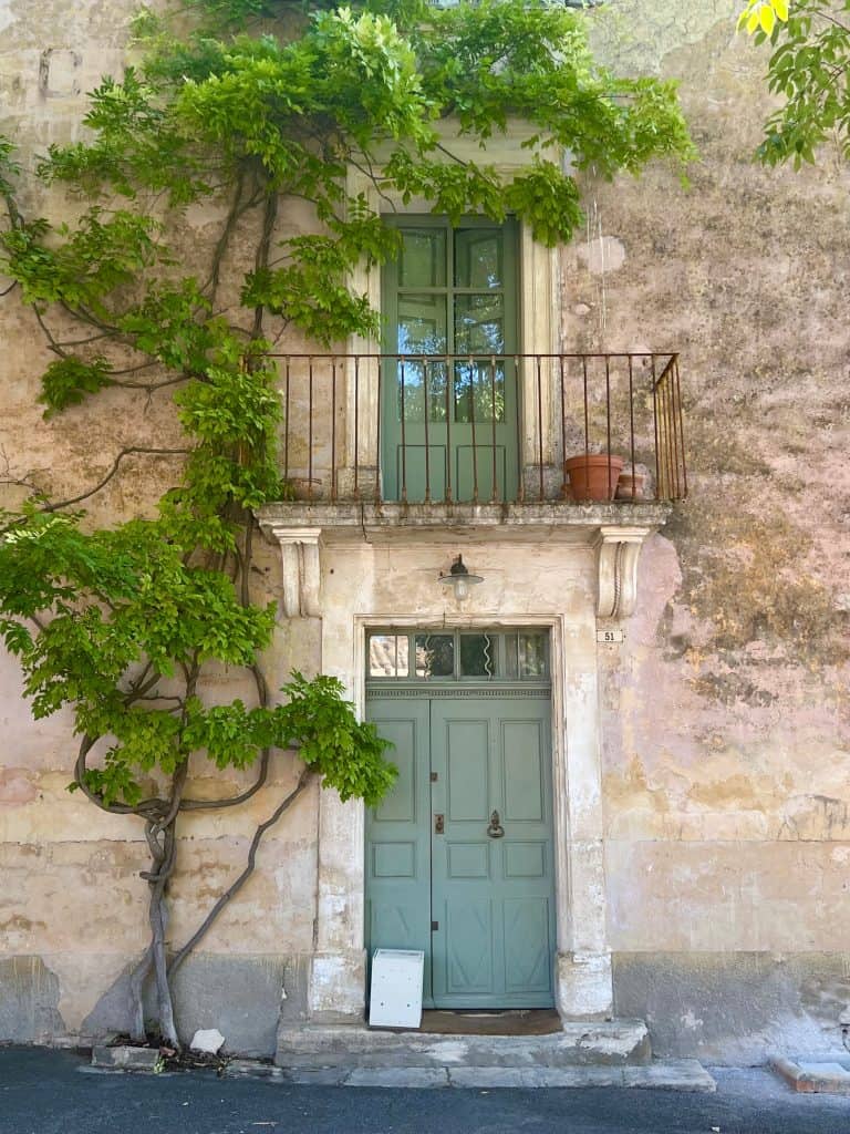 Doors and a Juliette balcony on a stone house in Goult