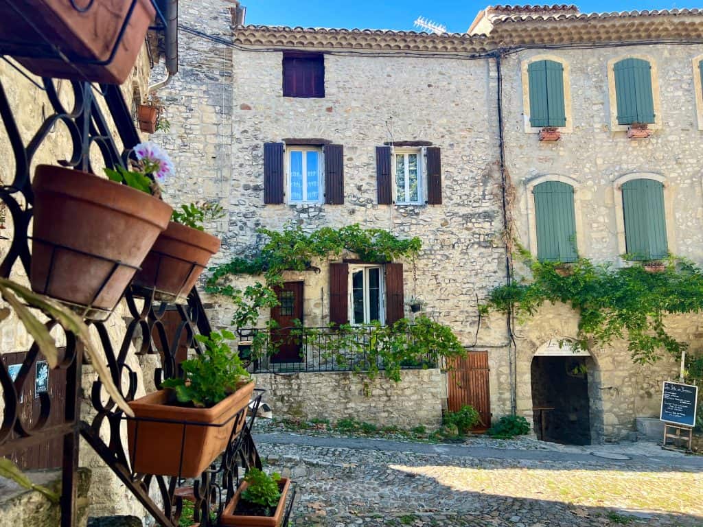 Plant pots and restaurant in the background in Vaison la Romaine