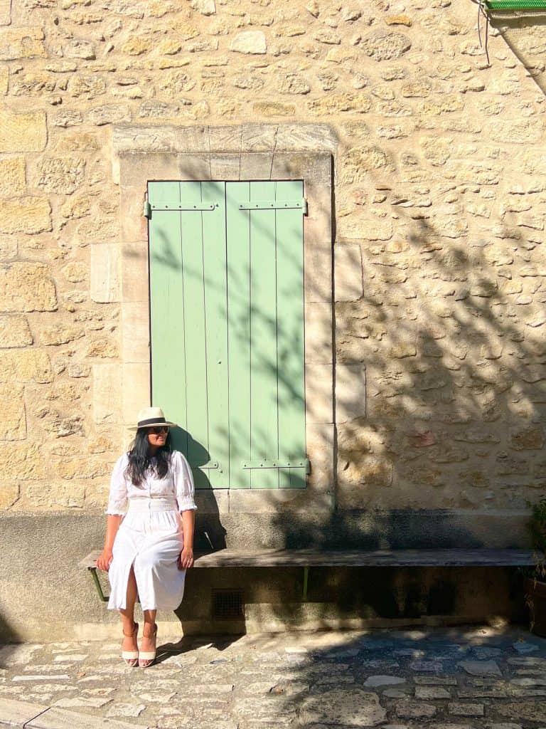 Bejal sitting outside pastel green door in Ansouis