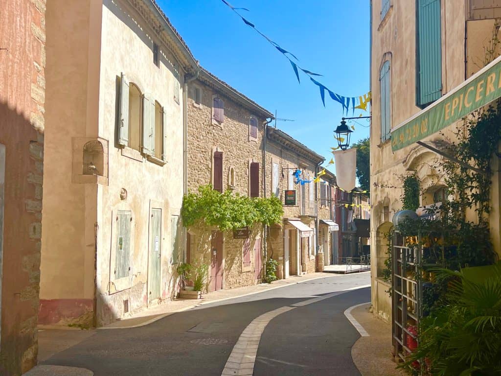 Beautiful villages to visit in Provence: Goult village street with shops and cafes on either side