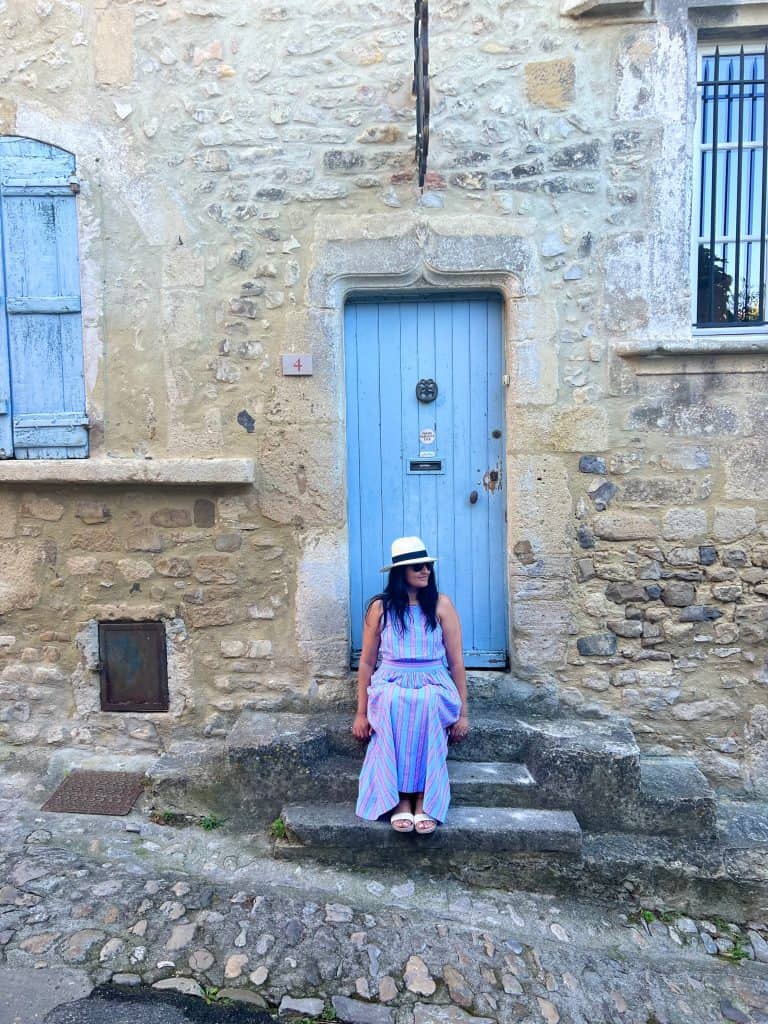 Beautiful villages to visit in Provence: Bejal sitting on stone step in Goult