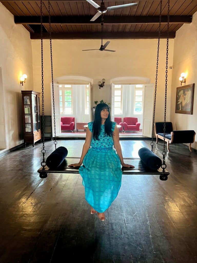 Eco-friendly hotels in Kerala: Bejal sitting on communal swing at Abad Dutch Bungalow