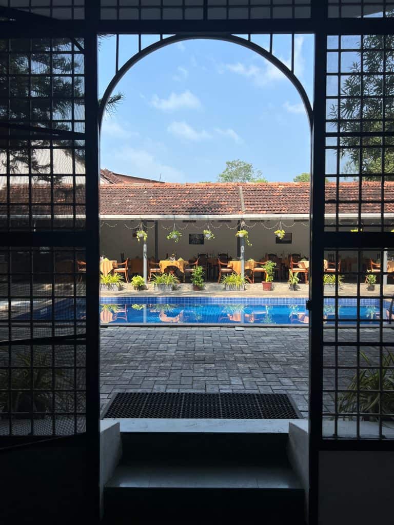 Doorway to pool area and restaurant at Abad Dutch Bungalow