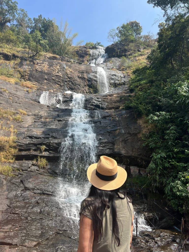 Bejal standing in front of Valara Waterfalls near between Fort Kochi and Munnar on the Madurai express Route.