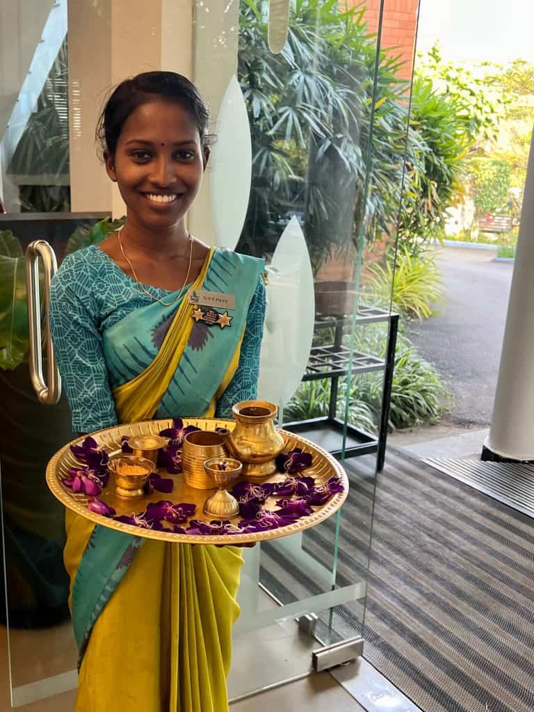Eco-friendly Hotels in Kerala: Traditional greeting of bindi and garlands at Green Leaf by staff