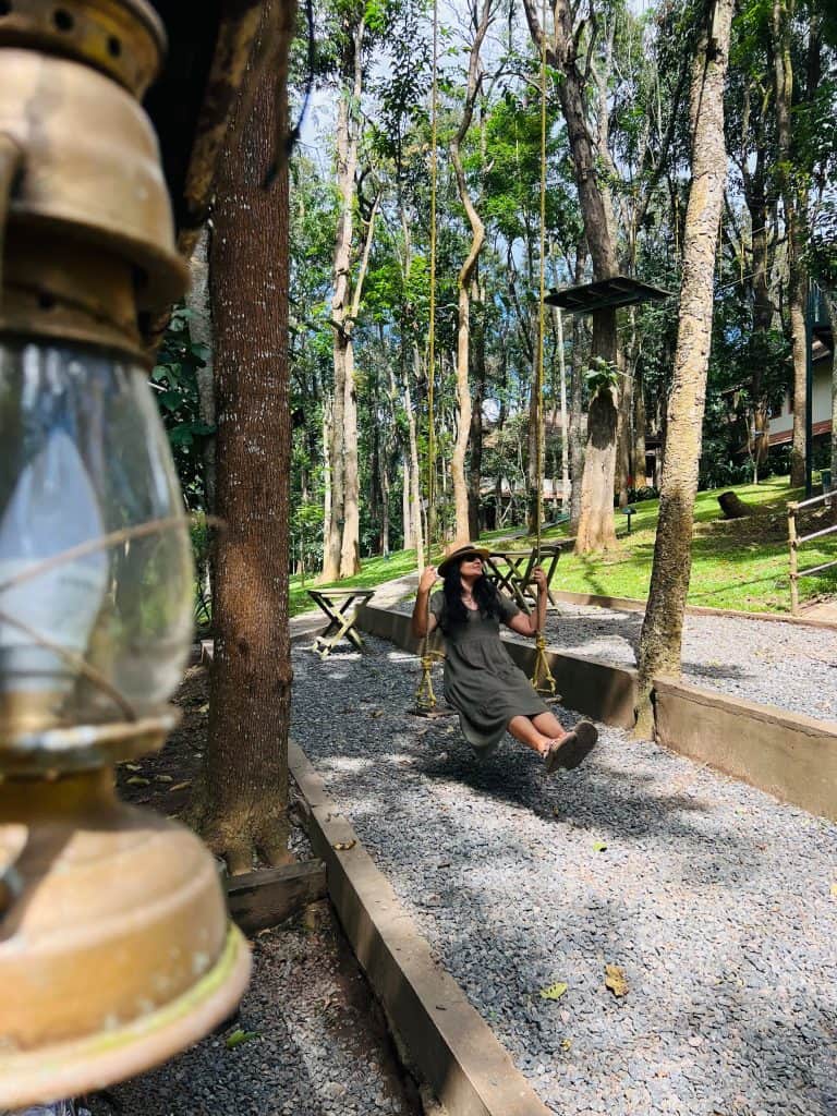 Bejal sitting on swing at Greenwoods Resort, Thekkady