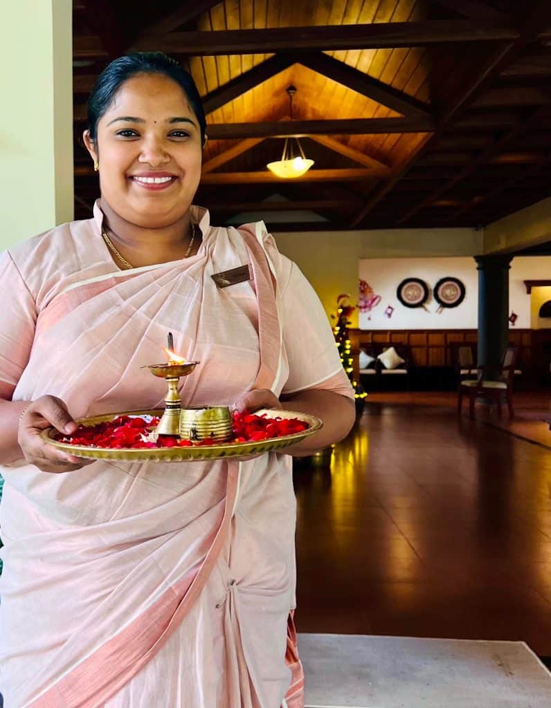 What you need to pack for Kerala:  Lady with traditional welcome greeting at Greenwoods Resort, Munnar
