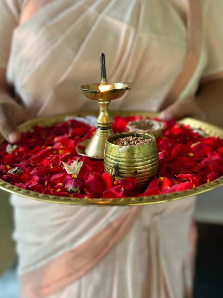 Traditional greeting plate with flowers and flower petals at Greenwoods Resort, Munnar