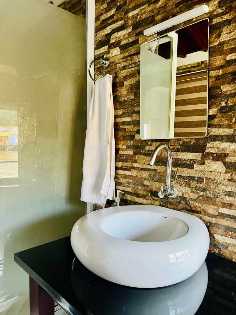 Eco-friendly Hotels in Kerala: Bathroom vanity area in Pickadly houseboat in the luxury Royal Suite