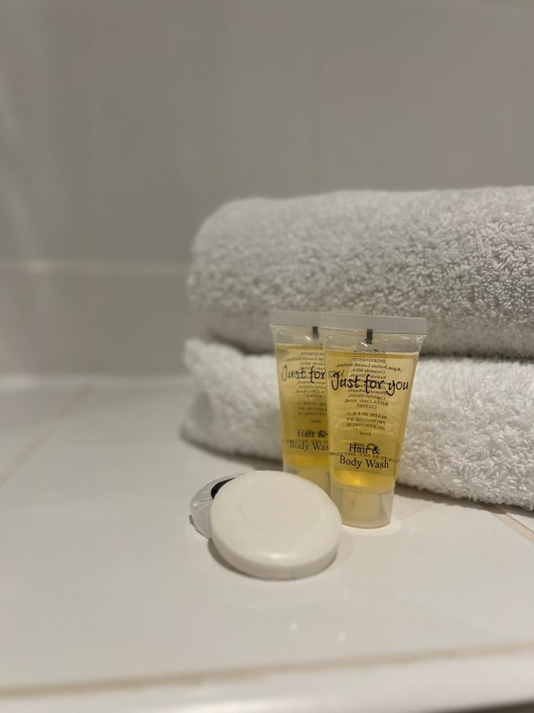 white towels with toiletries and soaps