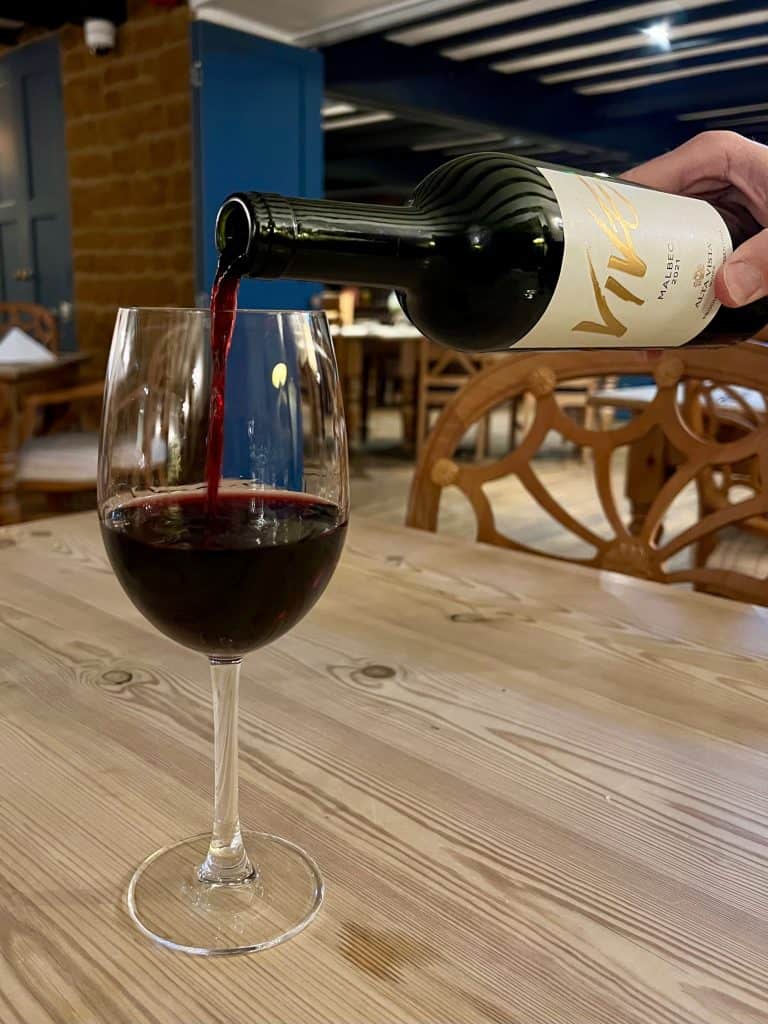 Beautiful Indian Food: The Marquess of Exeter: Malbec red wine being poured from bottle into glass