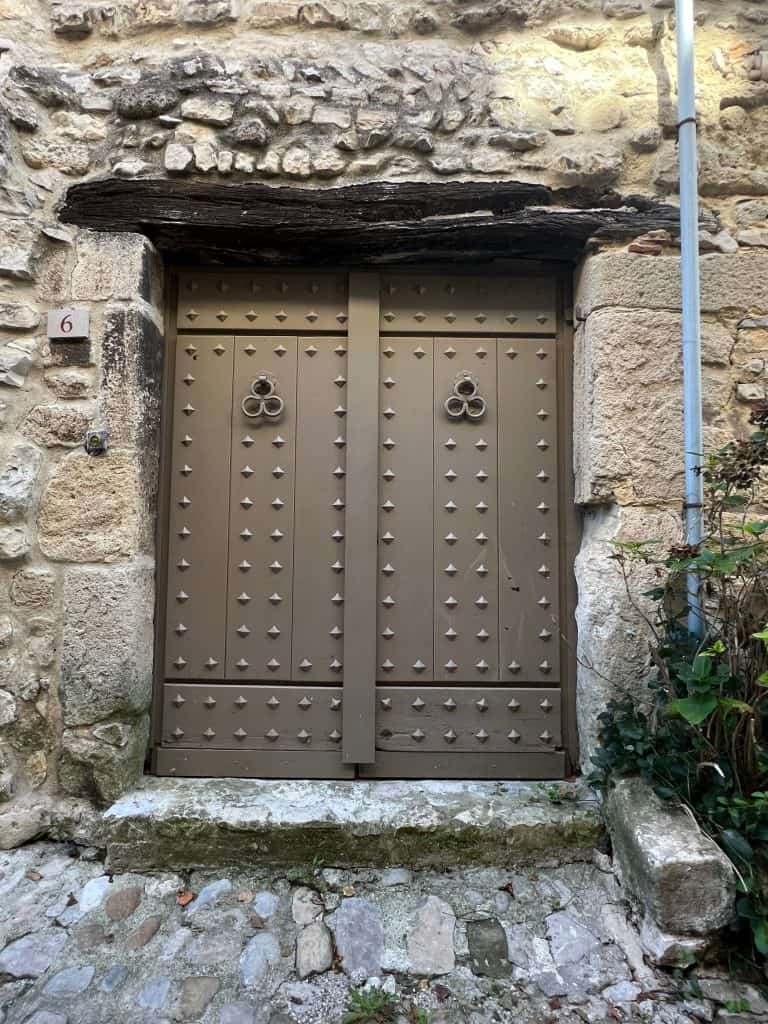 Brown old door with studs in Vaison la Romaine