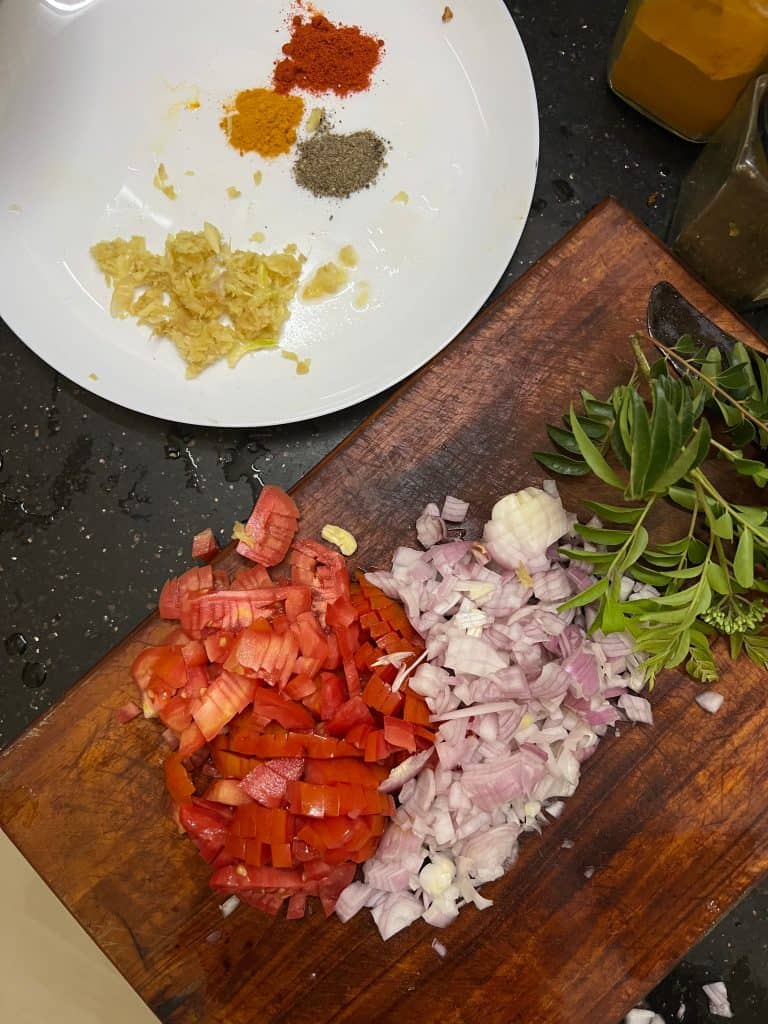 Chopped tomatoes, onions and a plate of spices at Sheeba's cookery class in Fort Kochi