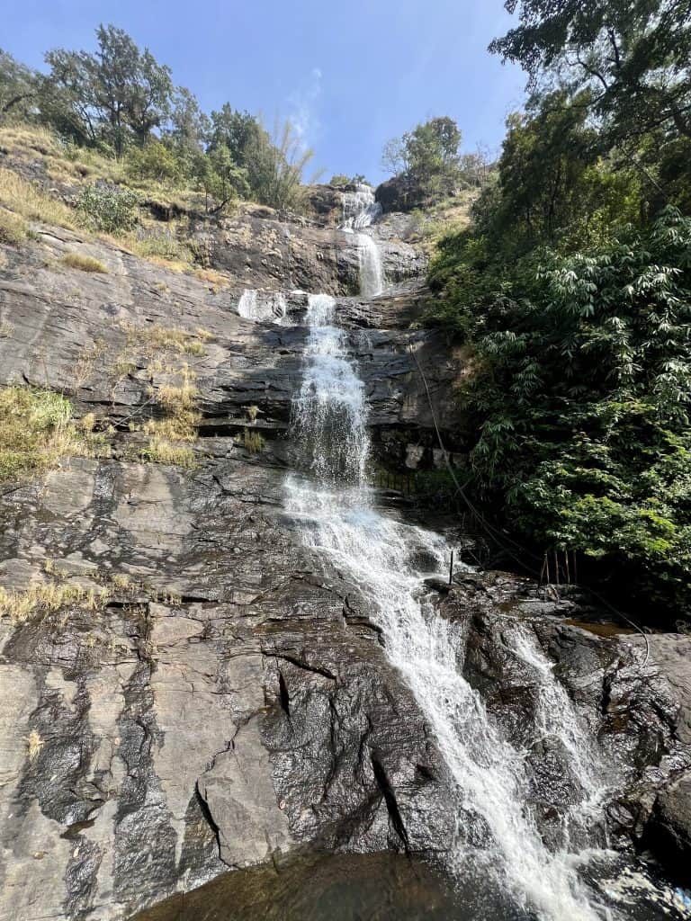 Things to do in Munnar, cheeyaparra Waterfalls from the roadside trickling down the brown rocks in a small stream-like fashion